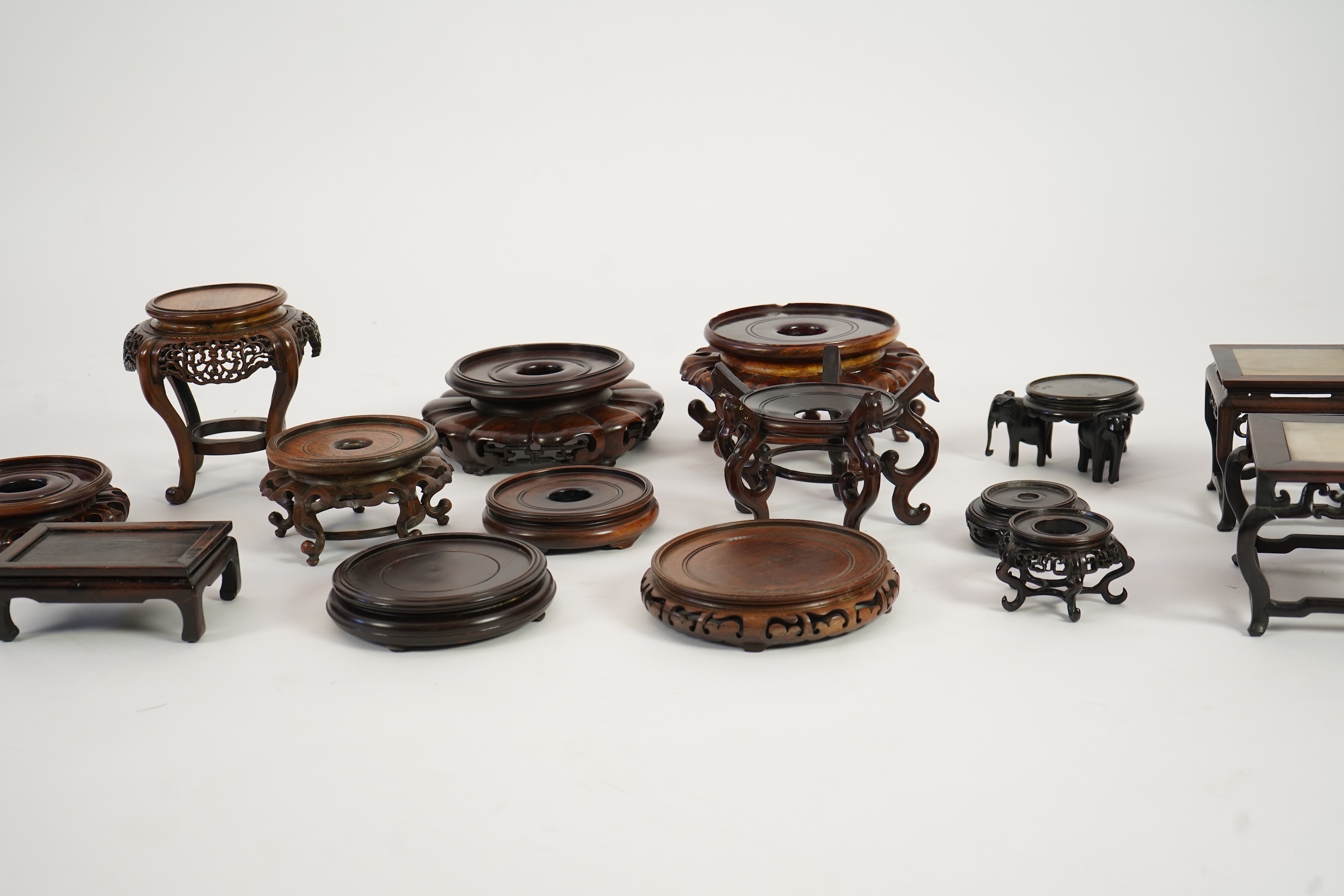 A group of sixteen Chinese hardwood stands together with a Japanese stand, 19th/20th century